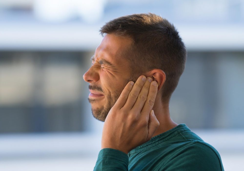 otitis-or-tinnitus-man-touching-his-ear-because-of-strong-earache-or-ear-pain-high-quality-photo